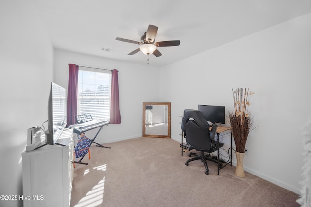 carpeted office featuring ceiling fan