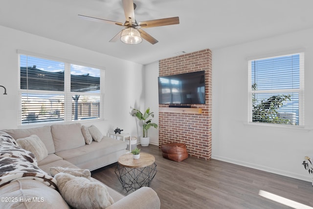 living room featuring hardwood / wood-style flooring, ceiling fan, and a wealth of natural light