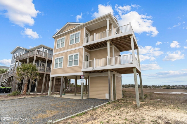 coastal inspired home featuring driveway and a carport