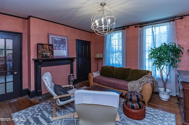 living room featuring a chandelier, dark hardwood / wood-style floors, and ornamental molding