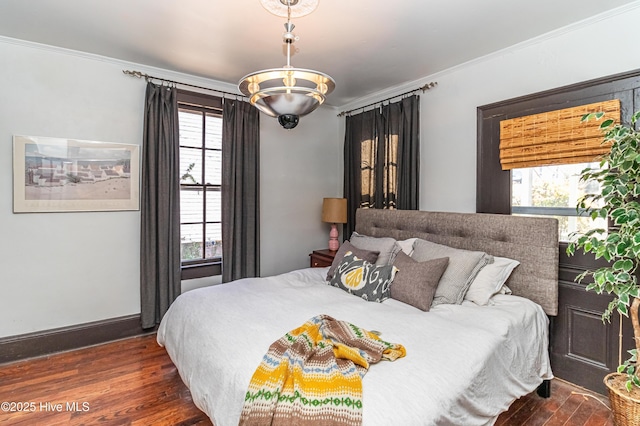 bedroom with crown molding and dark hardwood / wood-style floors