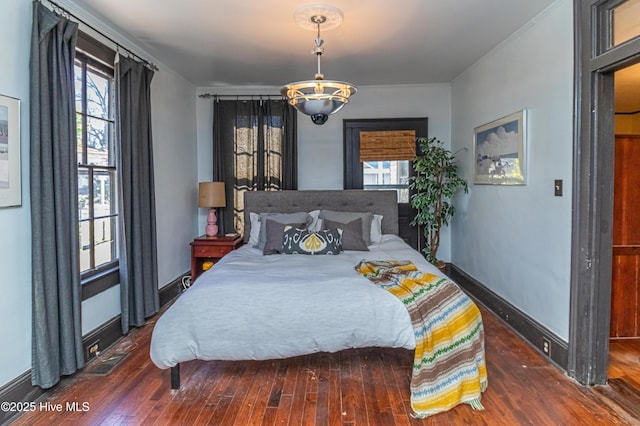 bedroom with dark hardwood / wood-style flooring