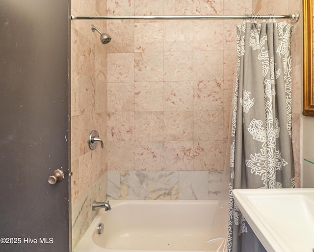 bathroom featuring shower / tub combo with curtain and sink