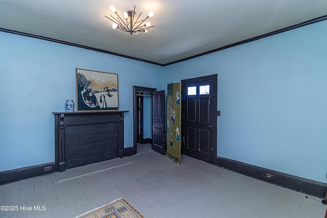 foyer entrance with hardwood / wood-style flooring, a chandelier, and ornamental molding