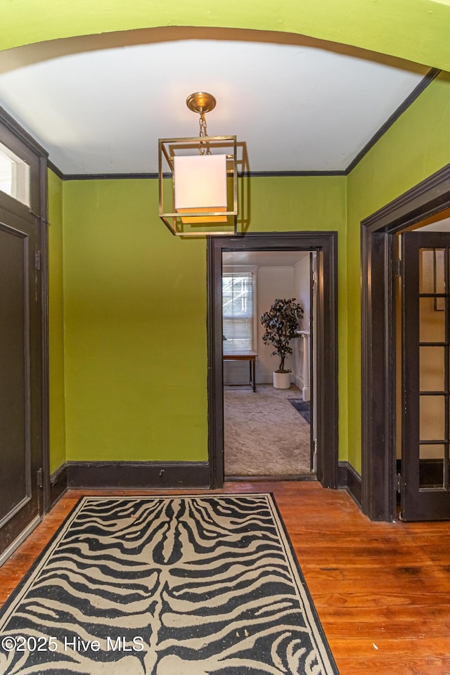 dining room with hardwood / wood-style flooring and ornamental molding