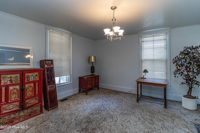 sitting room featuring carpet floors and a notable chandelier