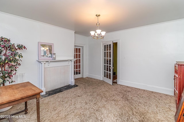 carpeted dining area with crown molding and an inviting chandelier