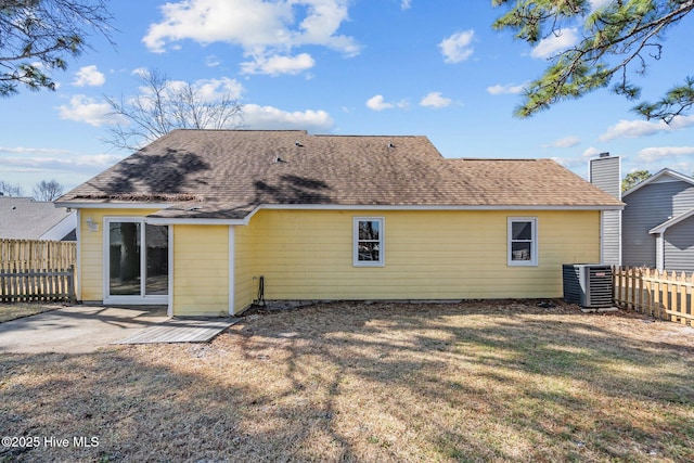 back of property featuring a yard, a patio, cooling unit, and fence