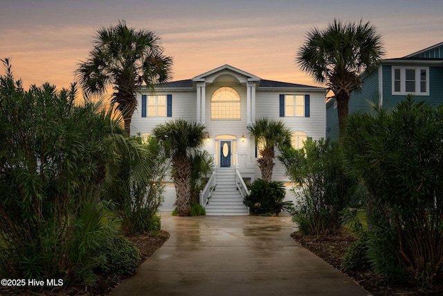 57 Craven St, Ocean Isle Beach, NC 28469 - raised beach house featuring concrete driveway and stairway