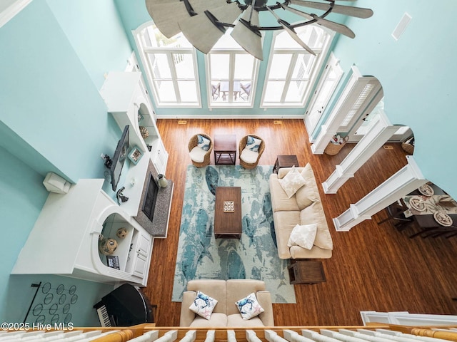 57 Craven St, Ocean Isle Beach, NC 28469 - living room featuring a towering ceiling, a ceiling fan, and healthy amount of natural light