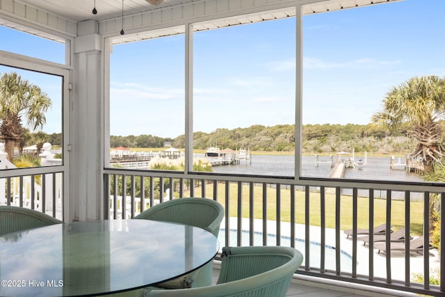 57 Craven St, Ocean Isle Beach, NC 28469 - sunroom / solarium with a water view and view of scattered trees