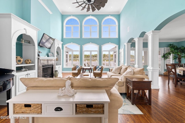 57 Craven St, Ocean Isle Beach, NC 28469 - living room with ornamental molding, dark wood-style floors, plenty of natural light, arched walkways, and decorative columns