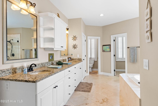 57 Craven St, Ocean Isle Beach, NC 28469 - bathroom featuring double vanity, a garden tub, and a tile shower