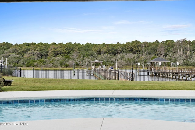 57 Craven St, Ocean Isle Beach, NC 28469 - view of swimming pool featuring a water view and a forest view