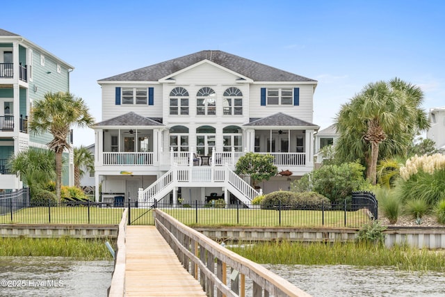 57 Craven St, Ocean Isle Beach, NC 28469 - back of property with ceiling fan, a fenced backyard, and a water view
