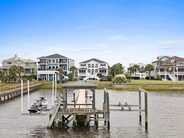 57 Craven St, Ocean Isle Beach, NC 28469 - dock area featuring boat lift, a water view, and a residential view