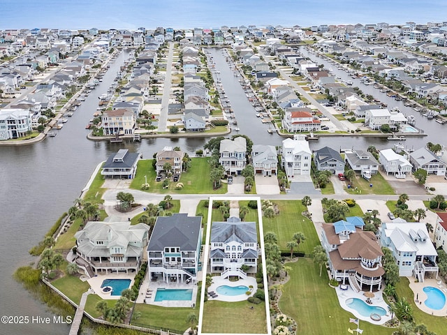 57 Craven St, Ocean Isle Beach, NC 28469 - aerial perspective of suburban area featuring a pool area and a large body of water