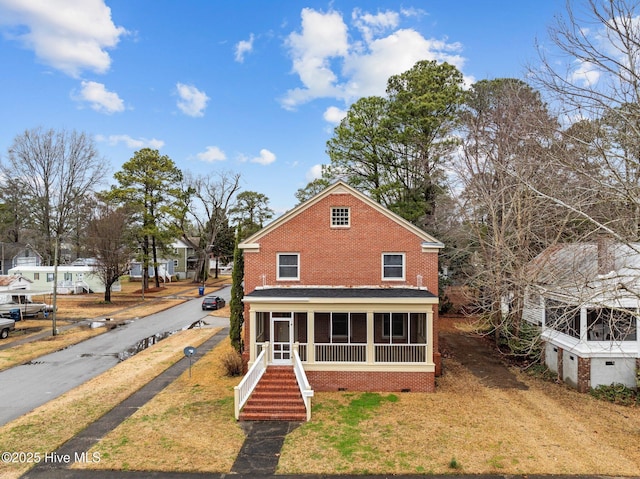 back of property with a sunroom