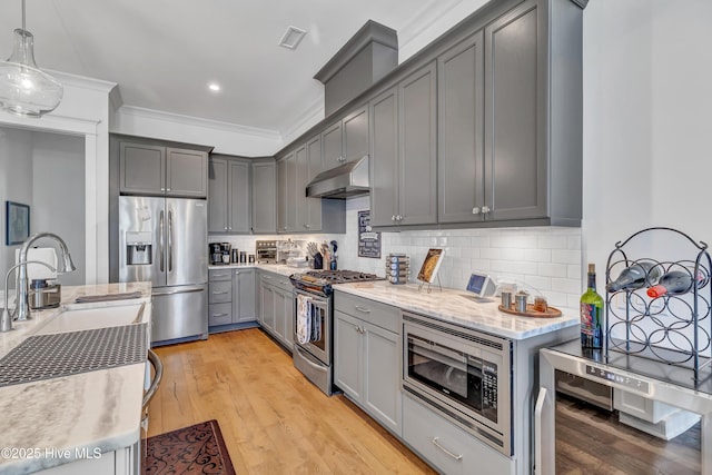 kitchen featuring decorative light fixtures, gray cabinetry, wine cooler, ornamental molding, and stainless steel appliances