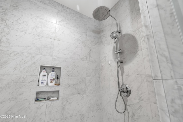 interior details featuring tiled shower