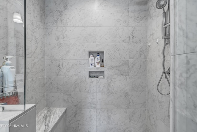 bathroom with tiled shower