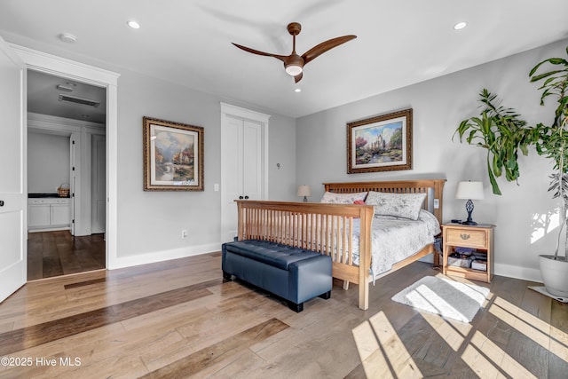 bedroom with light hardwood / wood-style floors, a closet, and ceiling fan