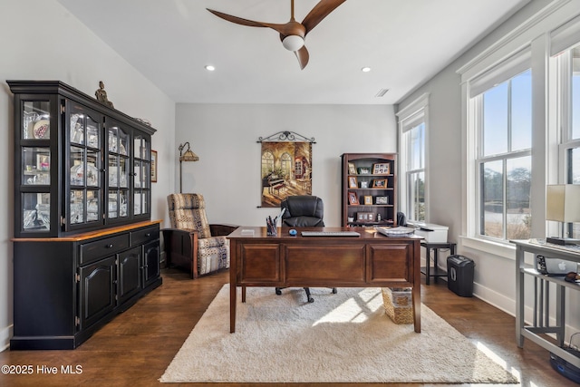 office area with dark wood-type flooring and ceiling fan