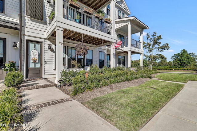 property entrance with a lawn