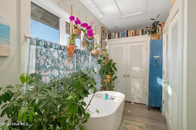 530 Contentnea Ave, New Bern, NC 28560 - bathroom featuring a closet, a soaking tub, and wood finished floors