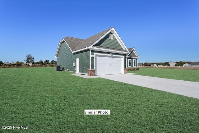 view of front of property with a garage, cooling unit, and a front lawn