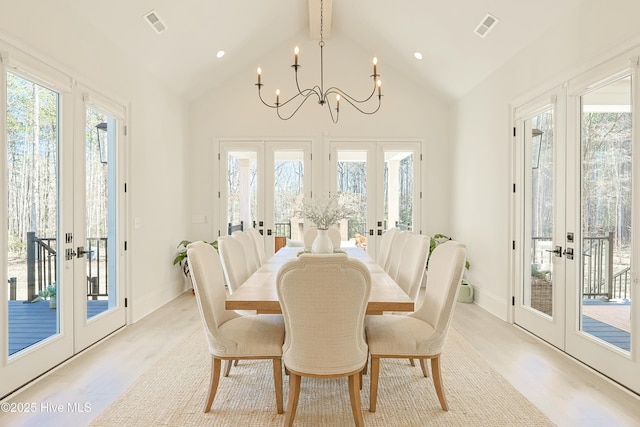 dining area featuring plenty of natural light, french doors, visible vents, and a notable chandelier