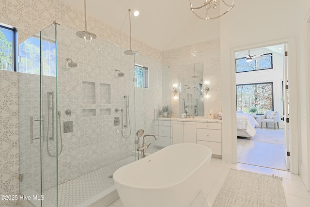 full bathroom featuring a wealth of natural light, a soaking tub, ensuite bath, and tile patterned floors