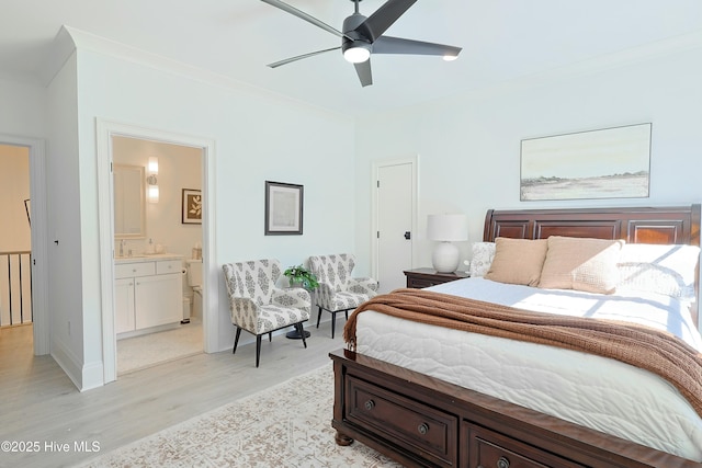 bedroom featuring light wood finished floors, ensuite bath, ornamental molding, and a ceiling fan