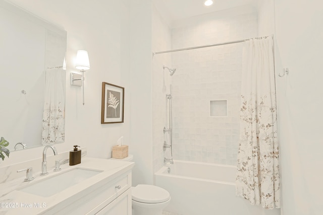 full bathroom featuring shower / bath combo, vanity, and toilet