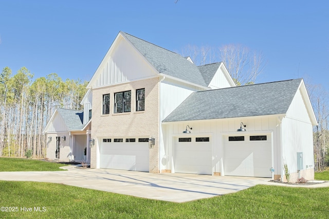 view of front of home with concrete driveway, a shingled roof, board and batten siding, and a front lawn