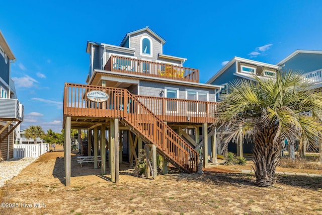 rear view of house with a wooden deck and a balcony