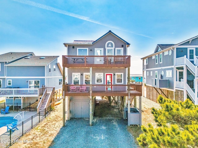 rear view of house with a carport and a balcony