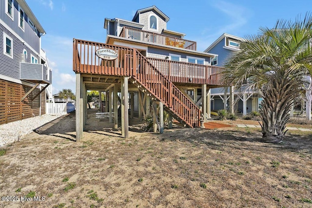 rear view of house featuring a wooden deck