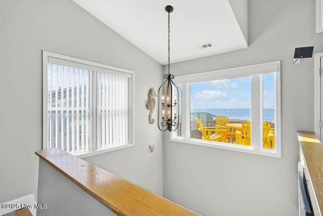 interior details with a water view and an inviting chandelier