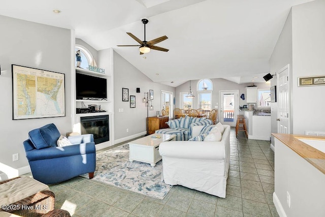 tiled living room featuring ceiling fan and vaulted ceiling