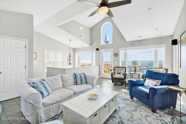 living room featuring ceiling fan, light tile patterned floors, high vaulted ceiling, and a wealth of natural light