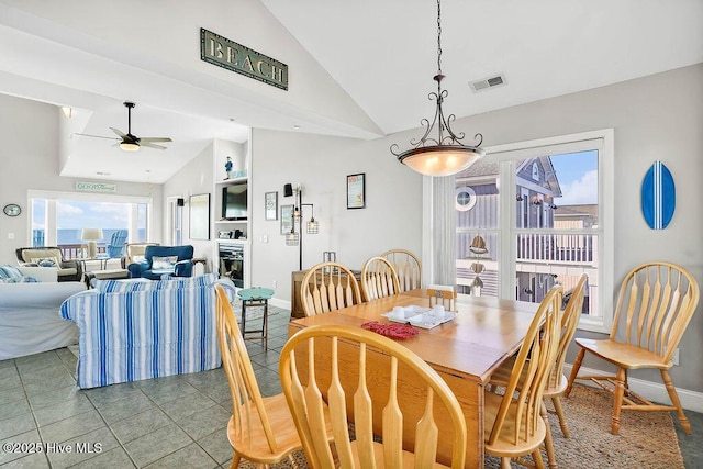 dining room featuring vaulted ceiling, tile patterned flooring, and ceiling fan