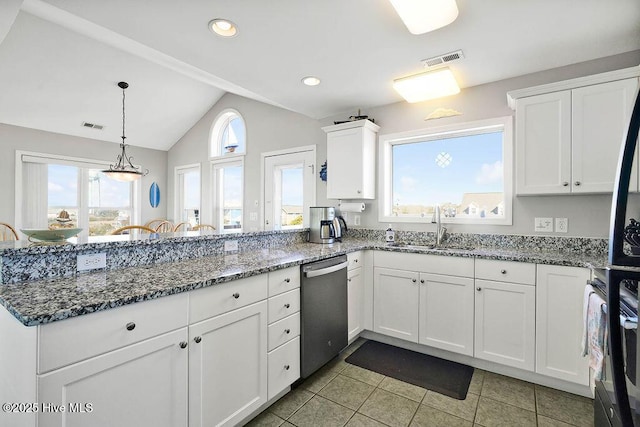 kitchen featuring sink, dishwasher, white cabinetry, and dark stone counters