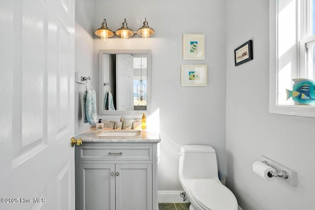 bathroom featuring vanity and toilet