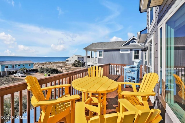 balcony featuring a deck with water view and a view of the beach