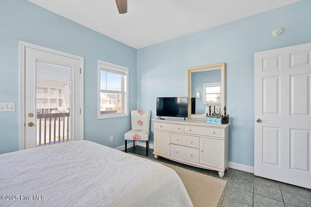 tiled bedroom featuring multiple windows, ceiling fan, and access to outside