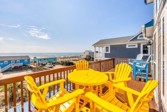 wooden terrace featuring a water view