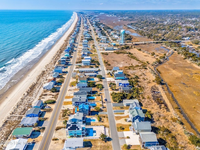 aerial view with a water view and a beach view