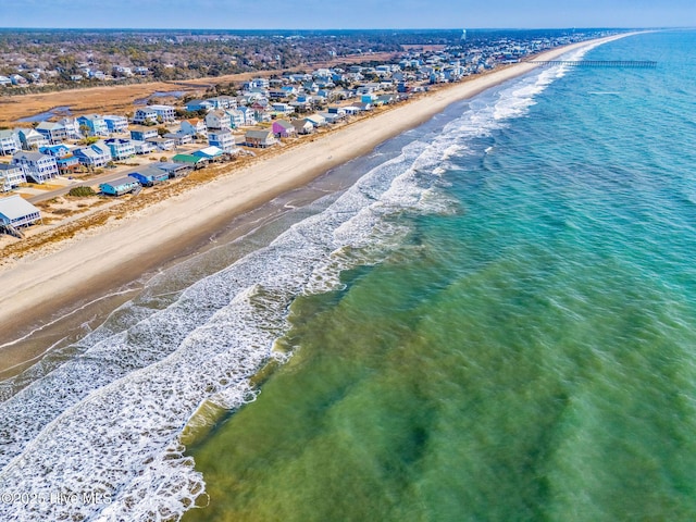 birds eye view of property featuring a water view and a view of the beach