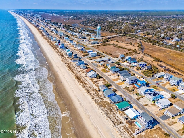 bird's eye view with a water view and a beach view